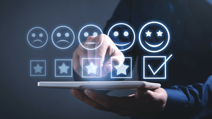 row of stars and emoji faces hovering over laptop