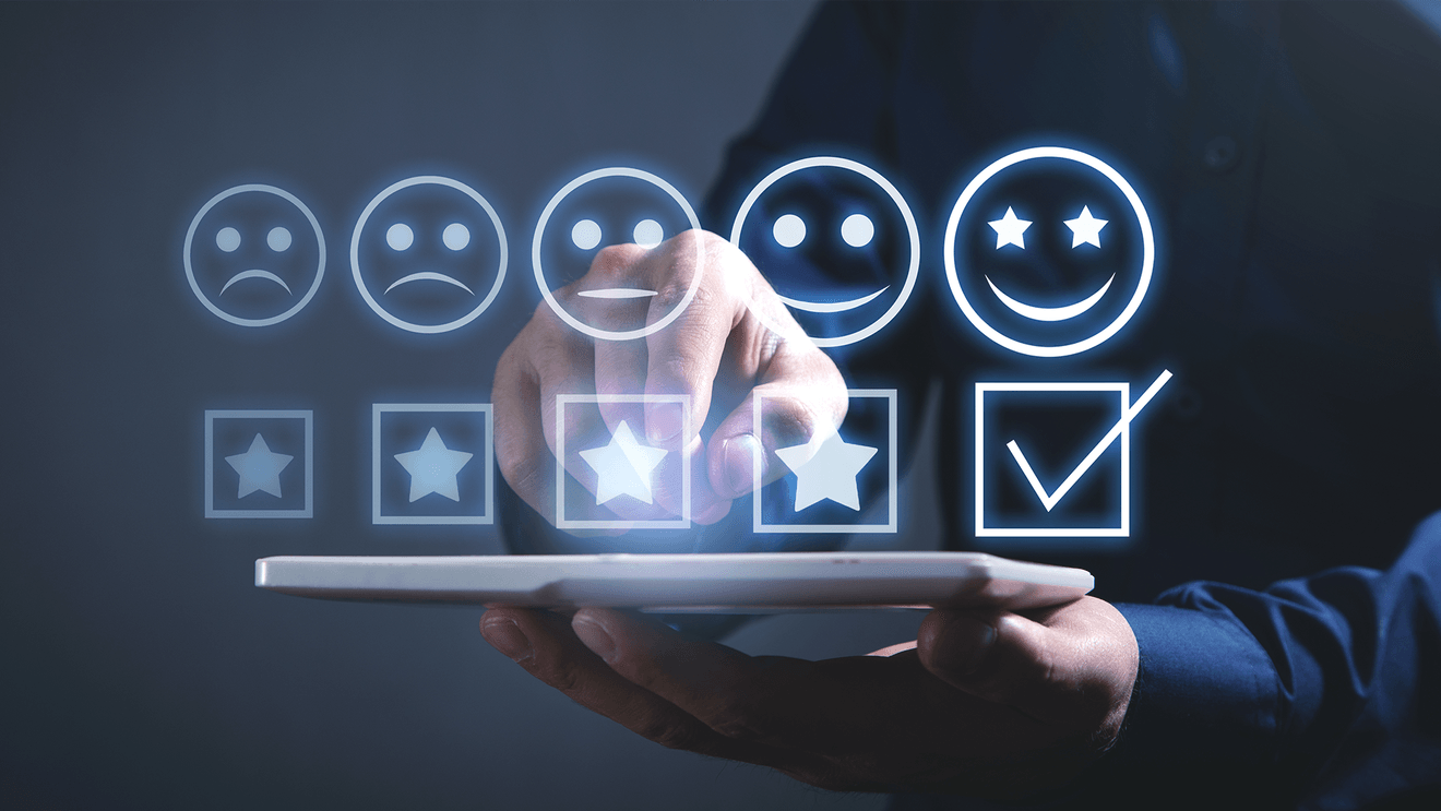 row of stars and emoji faces hovering over laptop