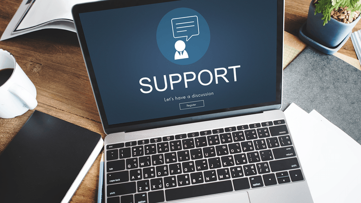 open laptop with screen that says support